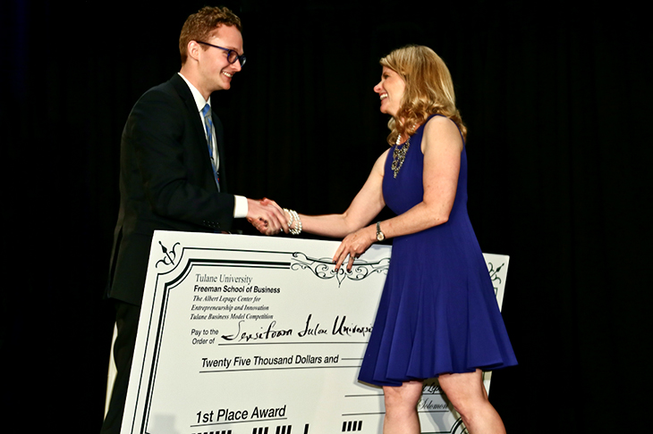 Chris Sloas, left, a 2015 graduate of the Tulane School of Science and Engineering, is congratulated by Stephanie Kleehammer, director of outreach and communications with the Lepage Center for Entrepreneurship and Innovation, after winning the 2016 Tulane Business Model Competition. (Photo by Guillermo Cabrera-Rojo)