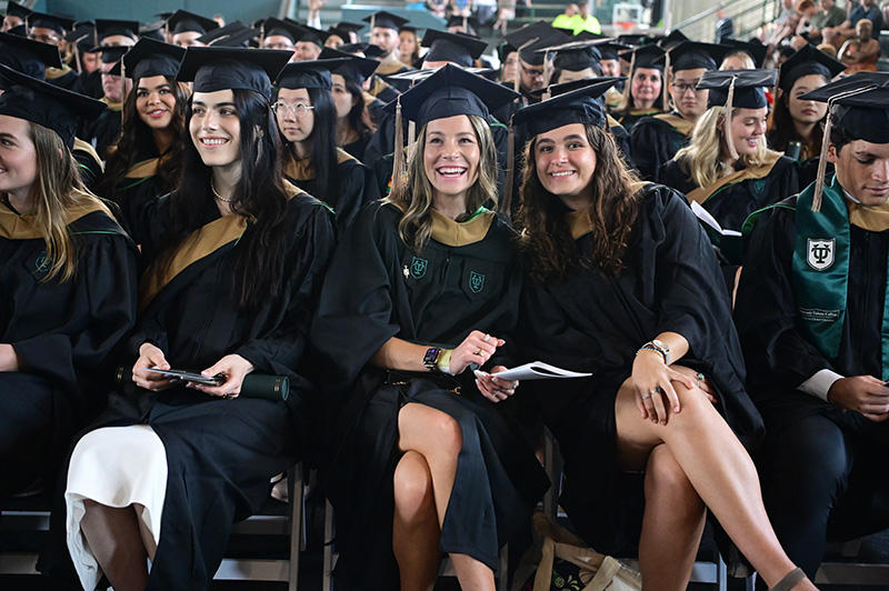 Degree candidates smile for the camera during Graduate Diploma Ceremony.