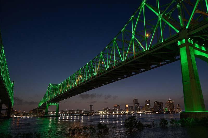 Photo of Crescent City Connection Bridge illuminated in green