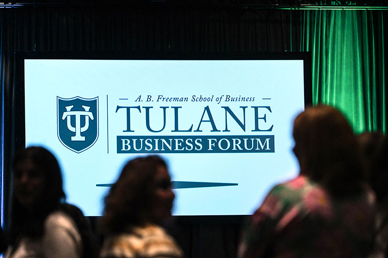 Tulane Business Forum logo on screen at 2023 forum.