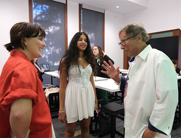 stuart weitzman with two students