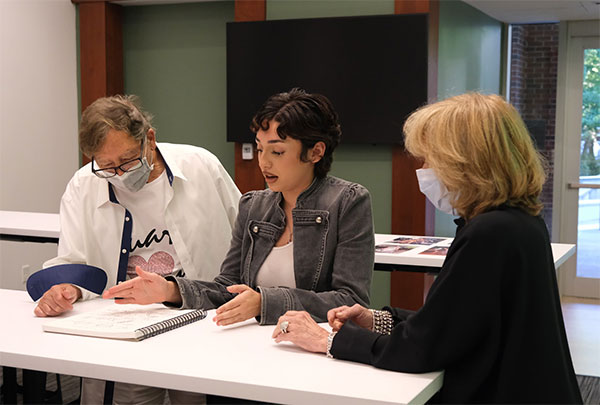 Stuart Weitzman reviews a student's work.