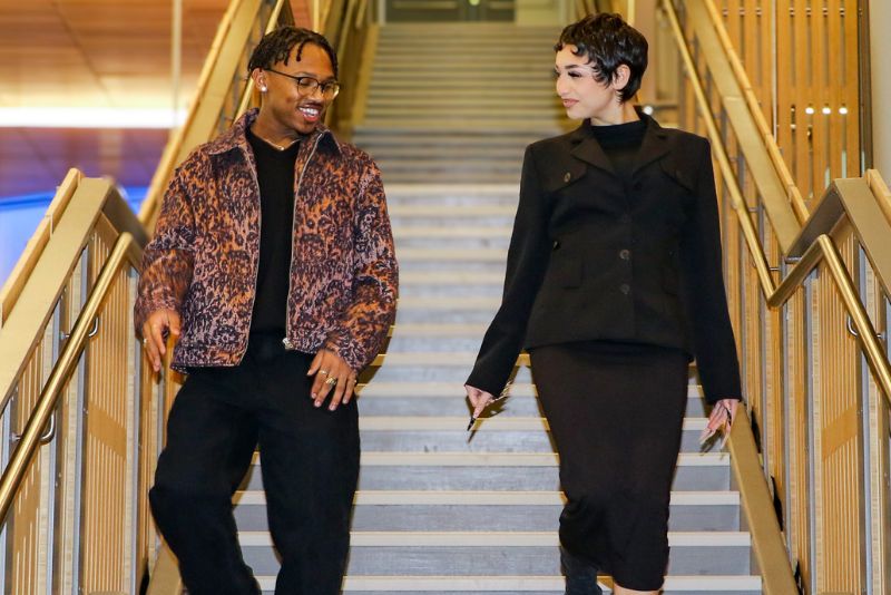 Chris Starr and Zoe Sanchez walking down stairs together. 