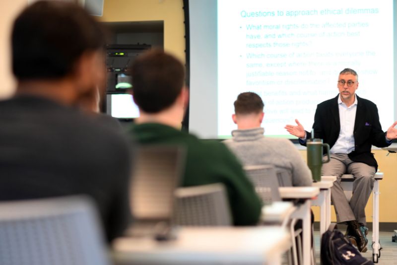 An instructor lectures during a business school class. 