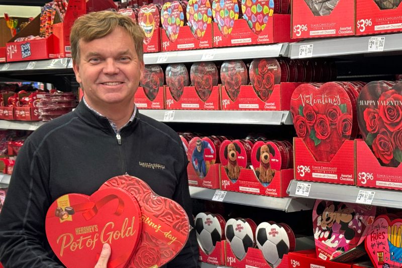 Rob Nelson hold a heart-shaped chocolate box for Valentine's Day.