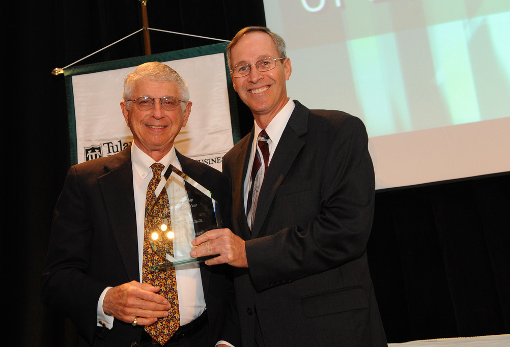 Sid Pulitzer, left, receives the 2011 Tulane Outstanding Entrepreneur of the Year Award from John Elstrott.