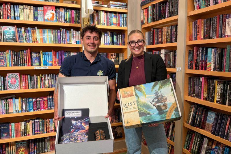 The Cypher Challenges team holding puzzle boxes from their startup. 