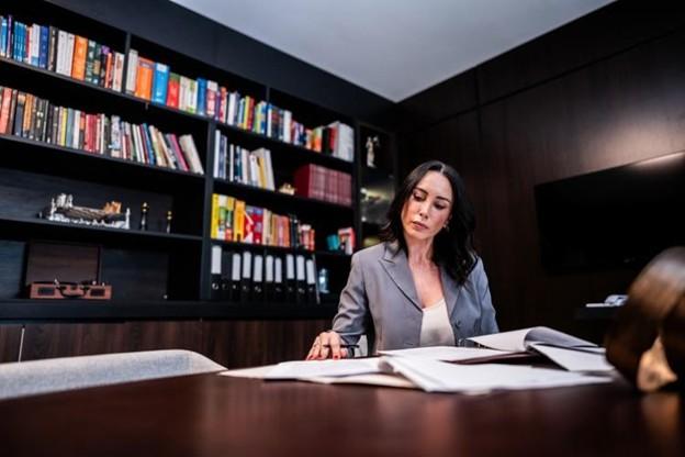 A forensic accountant looking at documents in an office. 