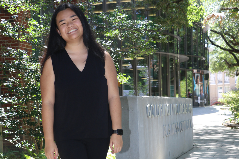 Student in front of Freeman Business School