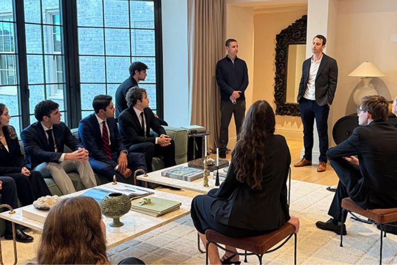 Students listen to a speaker during a meeting. 