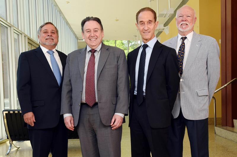 Ira Solomon, center left, dean of the A. B. Freeman School of Business, welcomed former Dean Meyer Feldberg, center right, to the business school on Wednesday (June 8). Also greeting Feldberg were former Deans Angelo DeNisi, left, and James McFarland. Together, the four administrators account for 35 years of Freeman School leadership. (Photo by Cheryl Gerber)