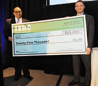 Disease Diagnostic Group's John Lewandowski, right, receives the $25,000 grand prize from Sherif Ebrahim, the Freeman School's director of entrepreneurship and innovation education.