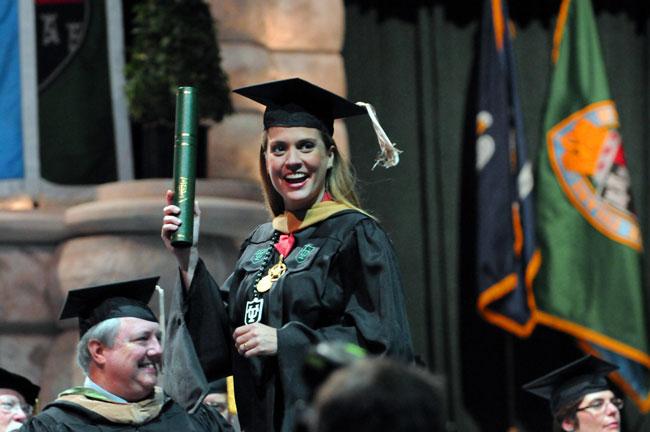 Maria Luisa Plaut shows off her just-received Master of Global Management diploma.