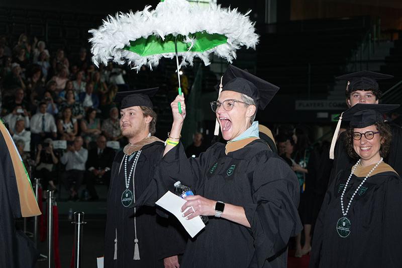 EMBA student JR Comeaux second lines into Fogelman Arena for graduation ceremony.