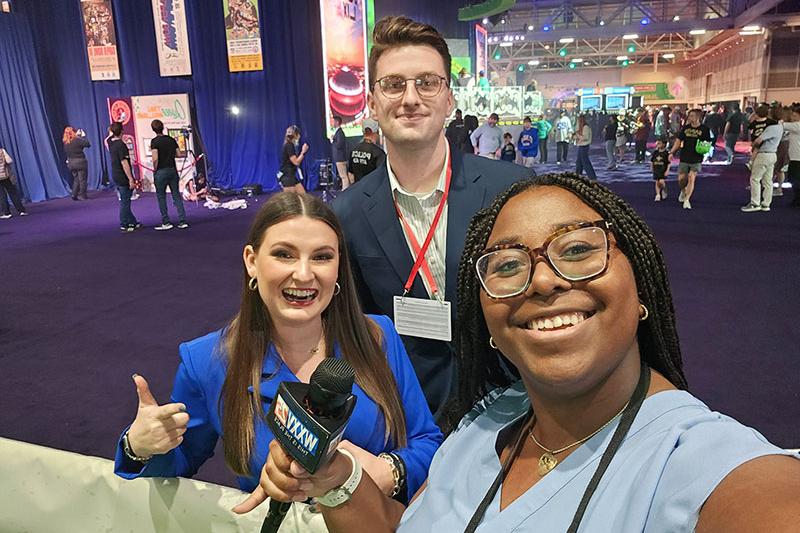 Macy Granger poses with media representatives at Super Bowl Experience