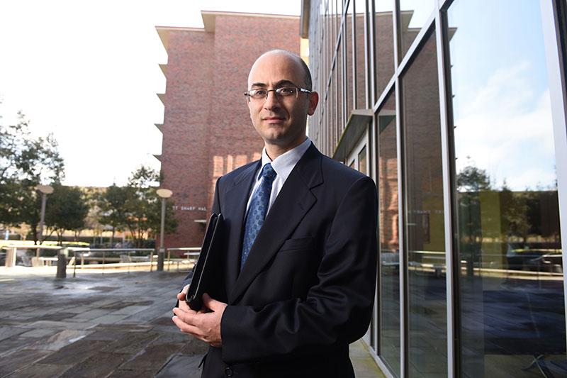 Portrait of Osman Kazan on patio of Goldring/Woldenberg Business Complex