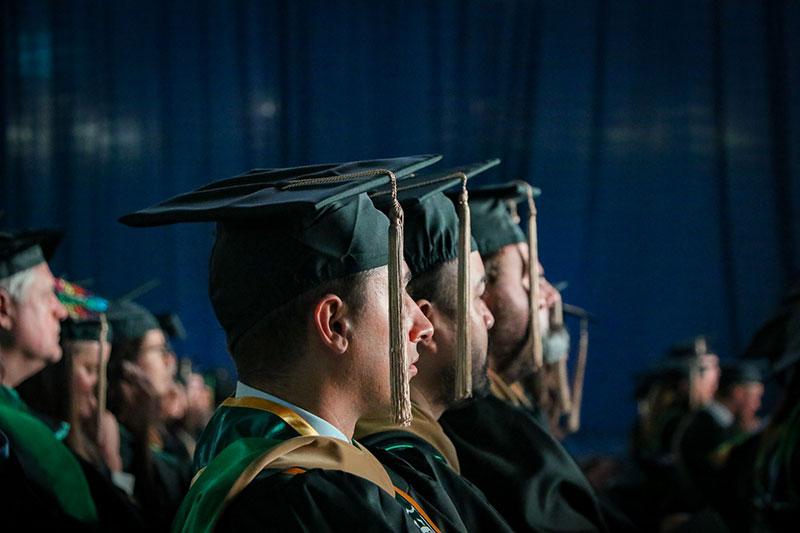 Closeup of graduates wearing caps with tassles