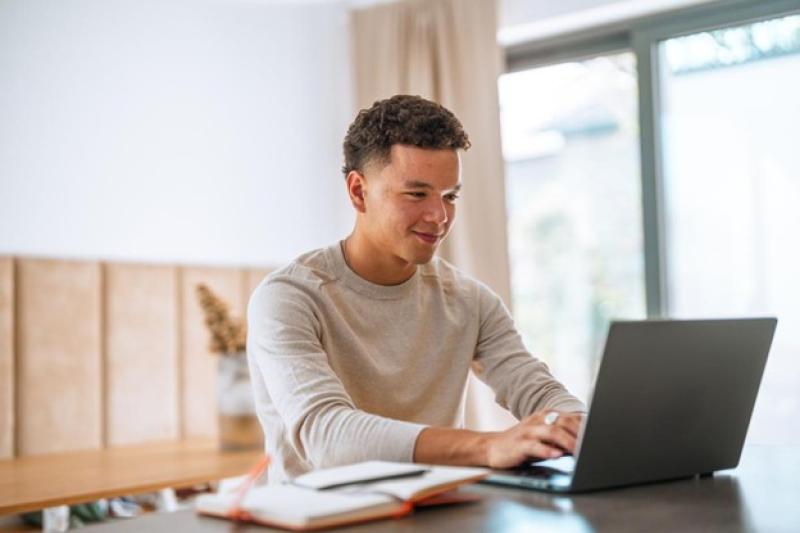 An MBA student works on a laptop.