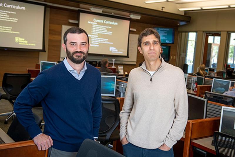 photo of Pierre Moses and Josh Herlands standing in a computer lab.