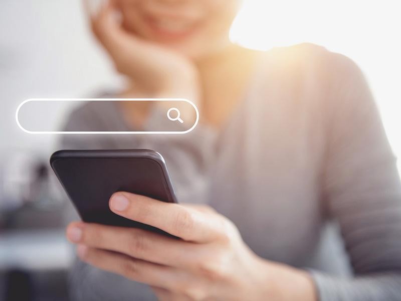 Stock image of person searching on phone