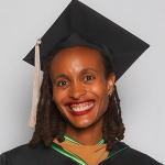 Desiree Graves Packard headshot in cap and gown