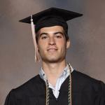 Charles Gaffney Smiling in a black graduation cap, gown, and honor cord.
