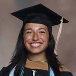 Serena Deutsch smiling woman in graduation cap and gown with light blue and green stoles.