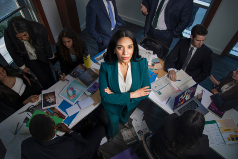 Chief Marketing Officer in office with team