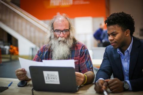 Capstone Raw Honey founder David Young, left, worked with Carlos Wilson (BSM/MACCT '16) to upgrade his accounting system as part of an innovative service learning collaboration between the Freeman School and Propeller, a nonprofit that supports social ventures. (Photo by Jennifer Zdon)