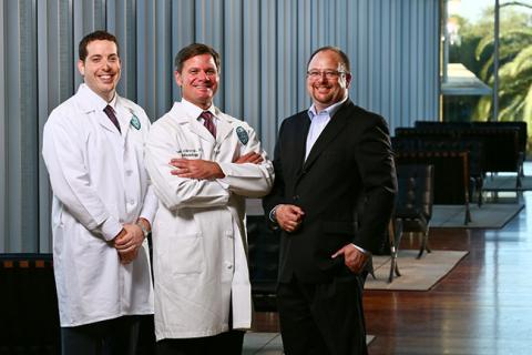 Anesthesiology resident Jonathan Eskander, left, with Michael Yarborough, head of the School of Medicine's residency program, and John Clarke, associate dean for graduate programs at the Freeman School, recently began the Professional MBA program.