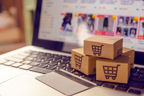 Stock photo illustrated online marketplaces with laptop and shopping cart boxes