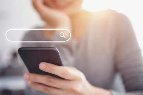 Stock image of person searching on phone