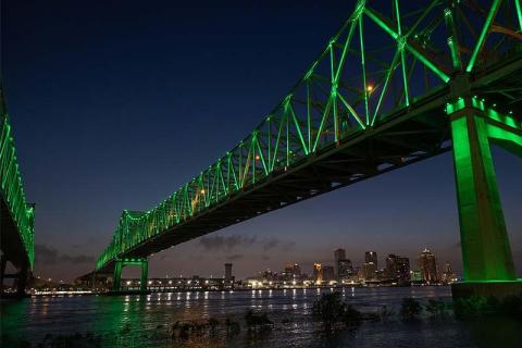 Photo of Crescent City Connection Bridge illuminated in green