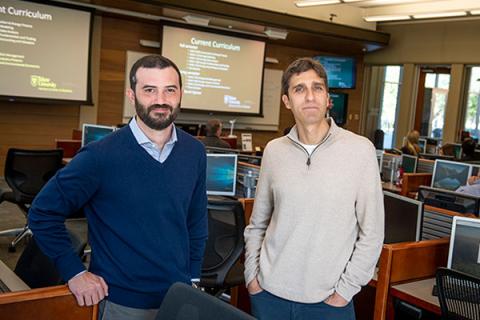 photo of Pierre Moses and Josh Herlands standing in a computer lab.