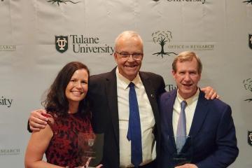 Claire Senot and Mike Burke pose with their awards with Dean Paulo Goes