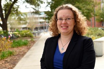 Assistant Professor of Finance Candace Jens finds that firms reduce their capital expenditures by up to 15 percent prior to elections.