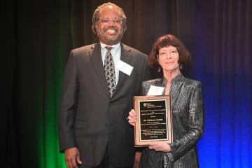 Erick Valentine poses with Adrienne Colella after awarding her the 2023 Albert Lepage Faculty Award for EDI