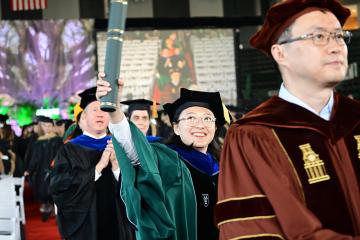 PhD recipient Hui Zhou celebrates receiving her degree